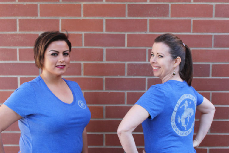 An image of two women wearing Clovis shirts