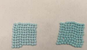 Photo of almost 200 bluish green fentanyl pills.