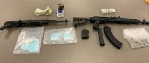 Photo of two assault rifles, more than 850 fentanyl pills, ammo, and cash.