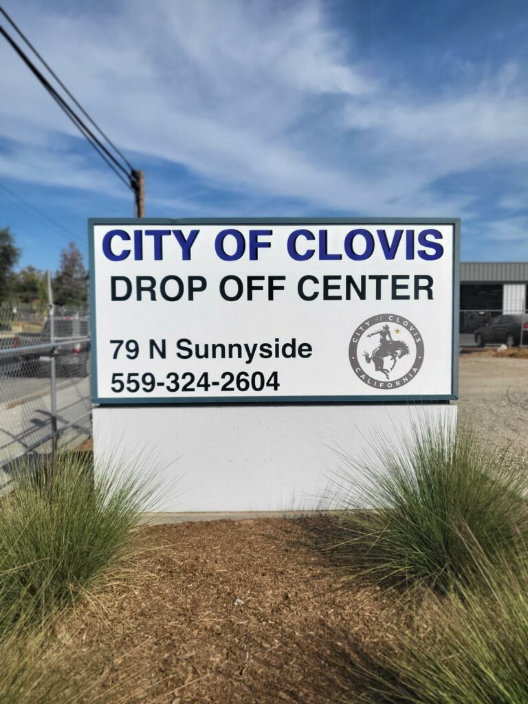 Sign reading "City of Clovis Drop Off Center, 79 N. Sunnyside, 559-324-2604"