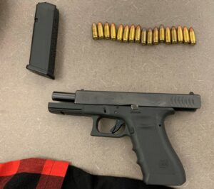 Photo of firearm located by suspects, with magazine and ammo.