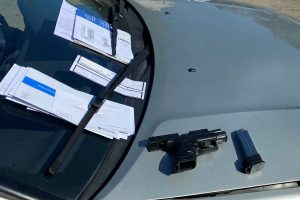 Photo of stolen vehicle, gun, and mail